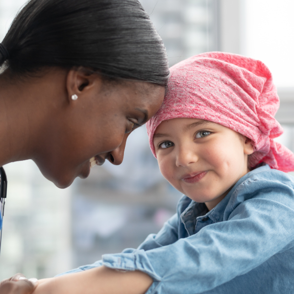 A woman is looking at a smiling girl